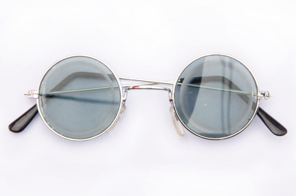 Lenticular Lenses - Types, Pros, Cons & Cost 2 Circular tinted glasses with lenticular lenses in the middle with clean background