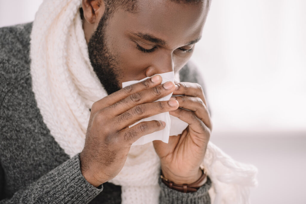 Can You Catch COVID-19 Through Your Eyes? 3 Ill african american man with runny nose holding napkin