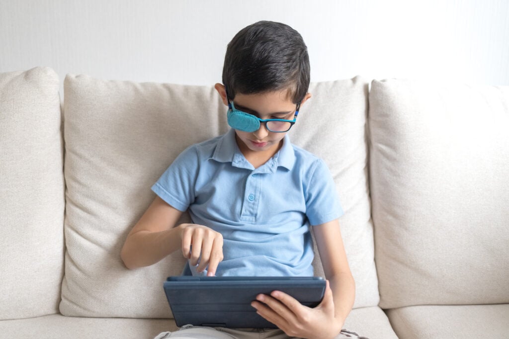 Types of Amblyopia (Lazy Eye) 4 Portrait of boy in glasses with amblyopia patch for glasses