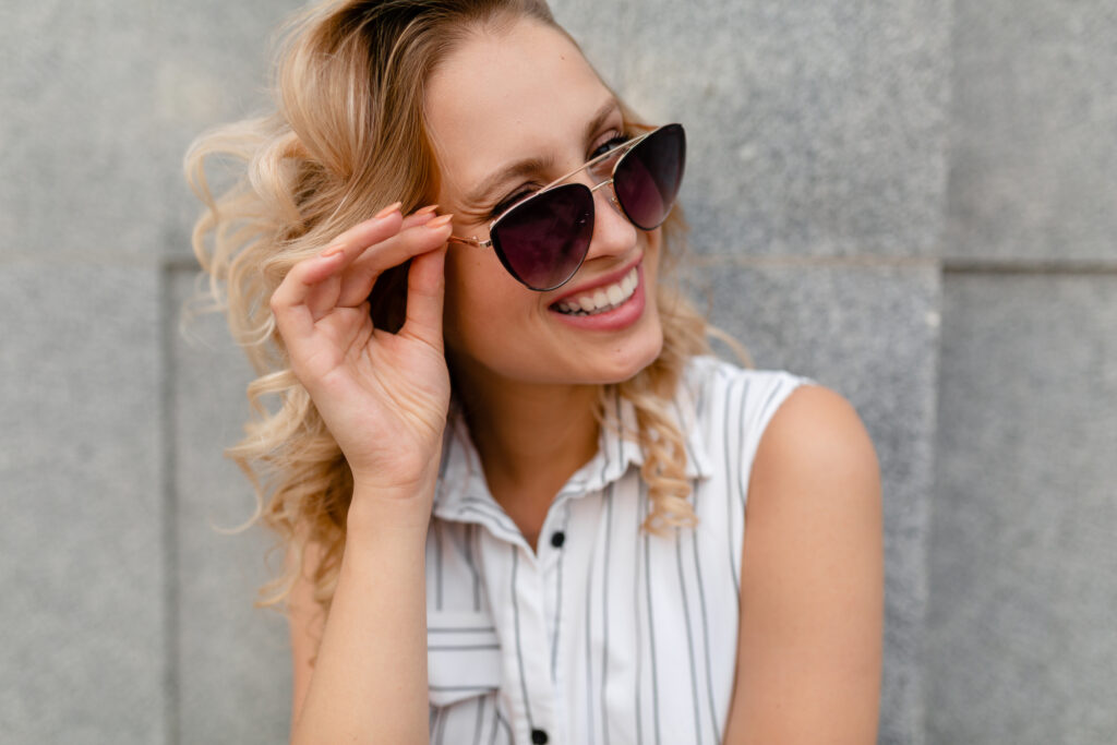 Pair Eyewear Review 4 Young attractive stylish blonde woman walking in city street wearing sunglasses