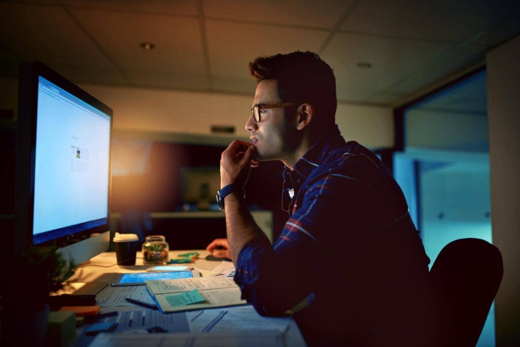 Blue Light and Your Eyes: Effects and Risks 3 young businessman using computer for work during the night